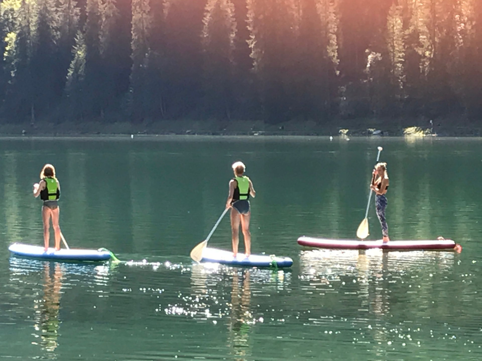 Sarah Clough paddleboarding on a mountain lake